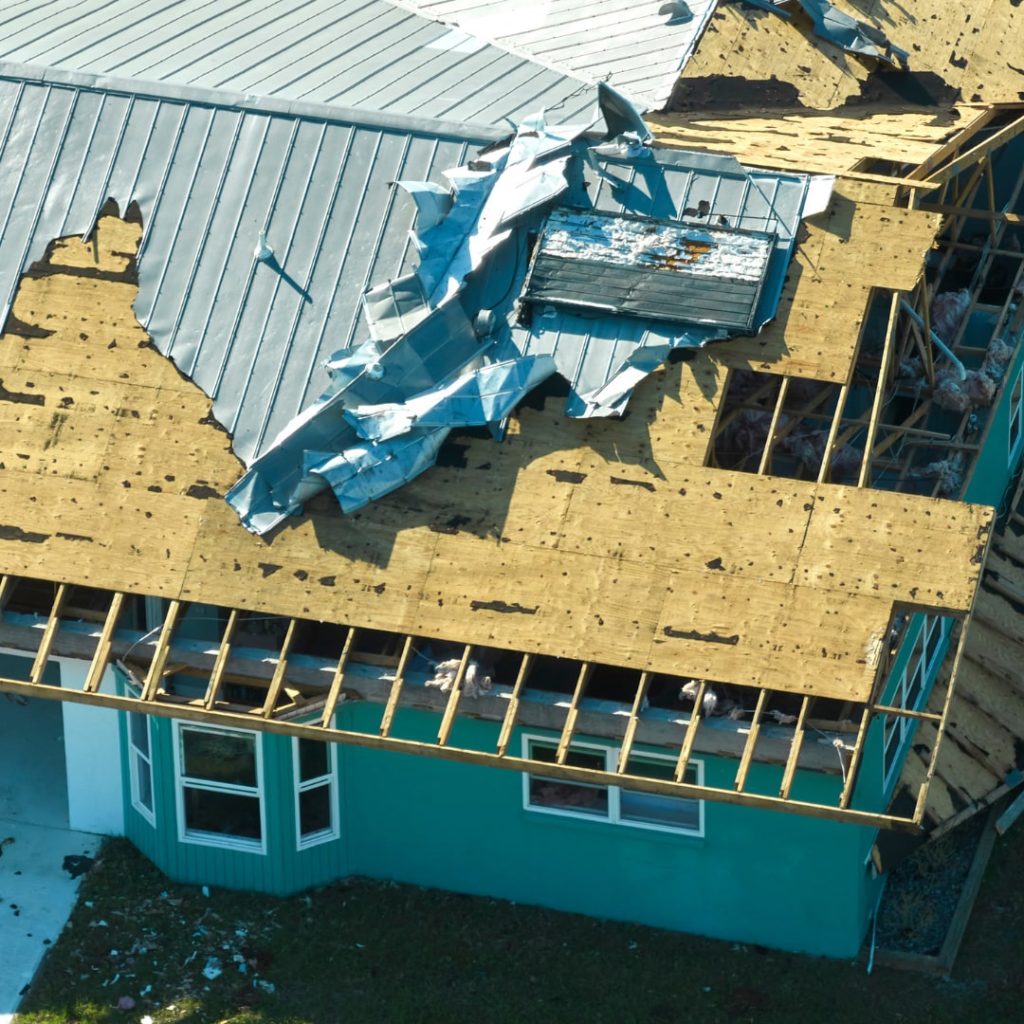 This is an image showing the consequences of natural disasters. A house in Florida was destroyed after the hurricane. The roof is completely damaged