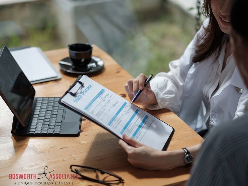 A female insurance broker presenting life insurance benefits to a male client.