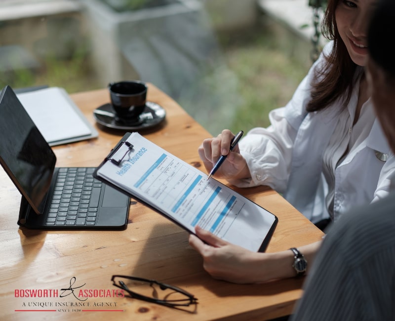 A female insurance broker presenting life insurance benefits to a male client.