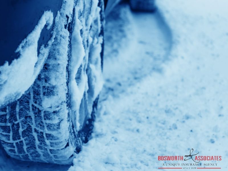 A closeup photo of a winter tire in the snow, showing how important is to prepare a vehicle for a winter.