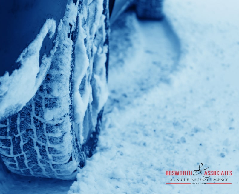 A closeup photo of a winter tire in the snow, showing how important is to prepare a vehicle for a winter.