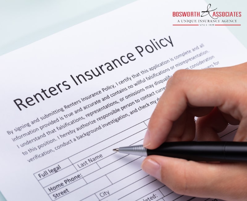 A person filling out a renters insurance policy form.