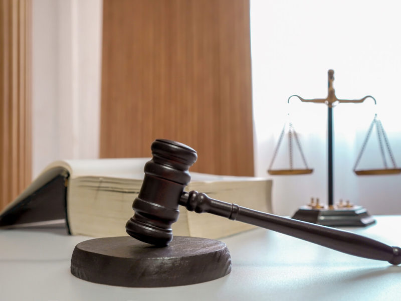 judges gavel law book and scale of justice on desk